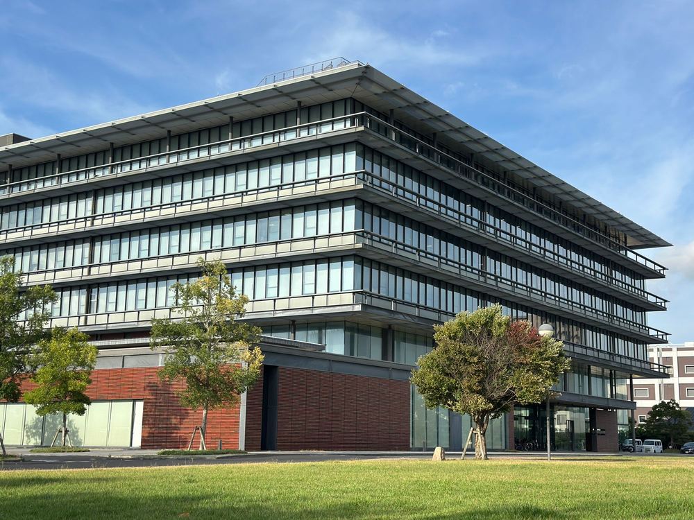 Four-story commercial building with a steel frame and a full glass curtain-wall exterior
